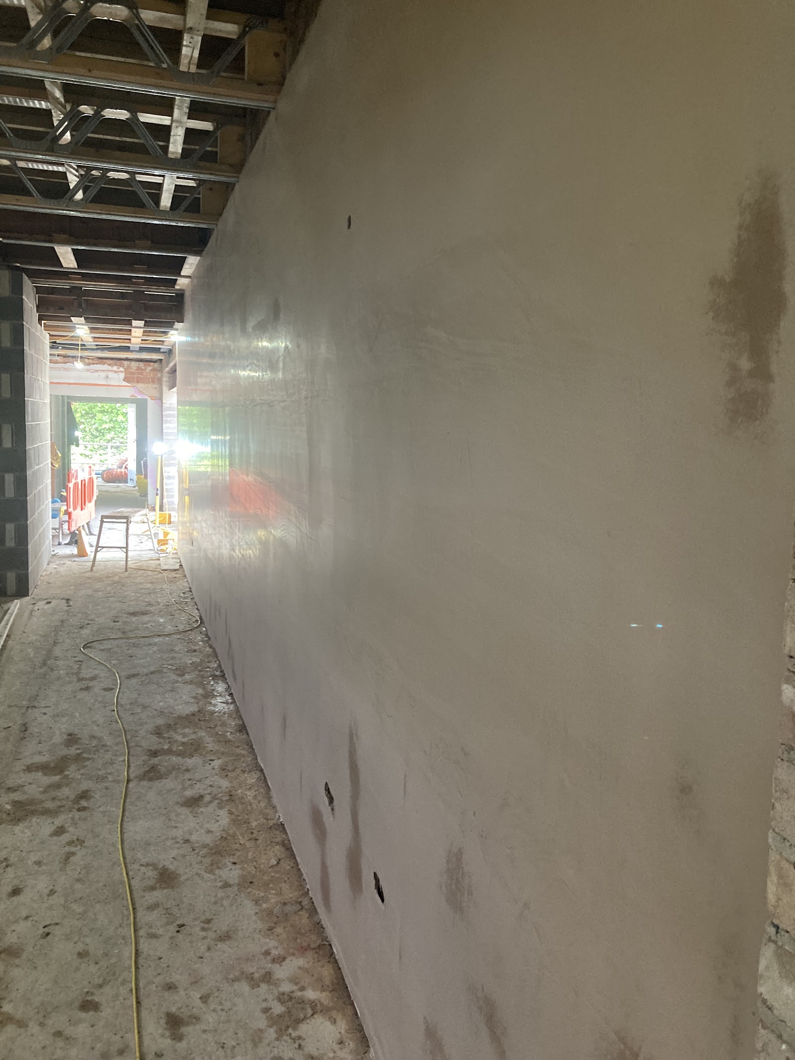 A long interior wall skimmed to a smooth, polished plaster finish